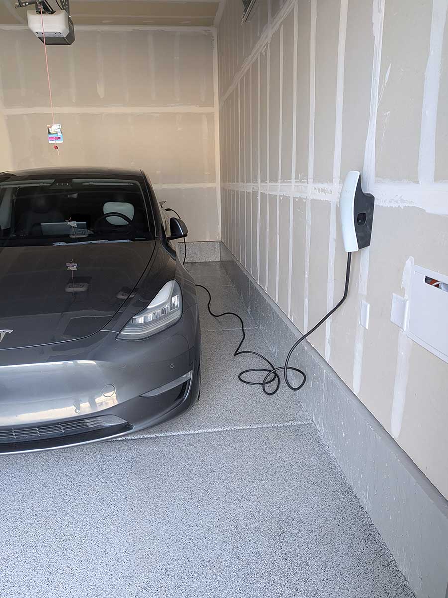 Tesla In Garage Getting Charged